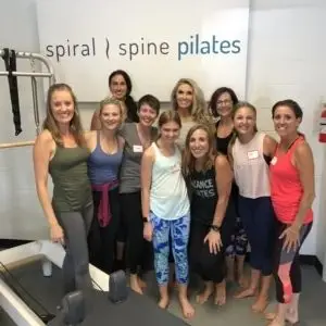 10 women standing in pilates studio after finishing Pilates instructor training