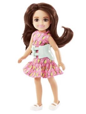 brown haired, white down with pink dress and scoliosis brace